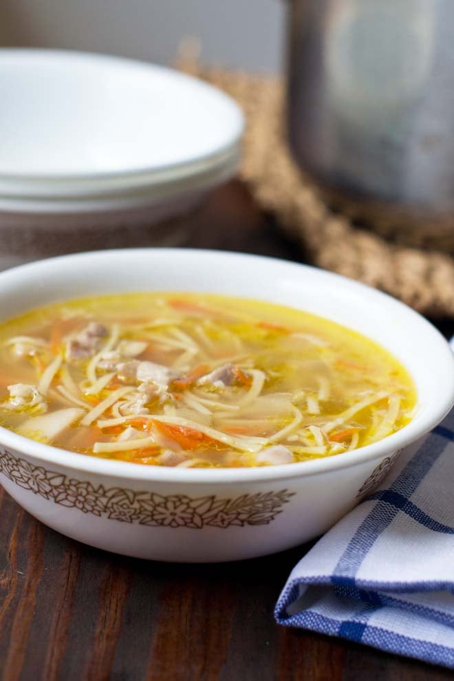 Homemake chicken noodle soup in a white bowl.