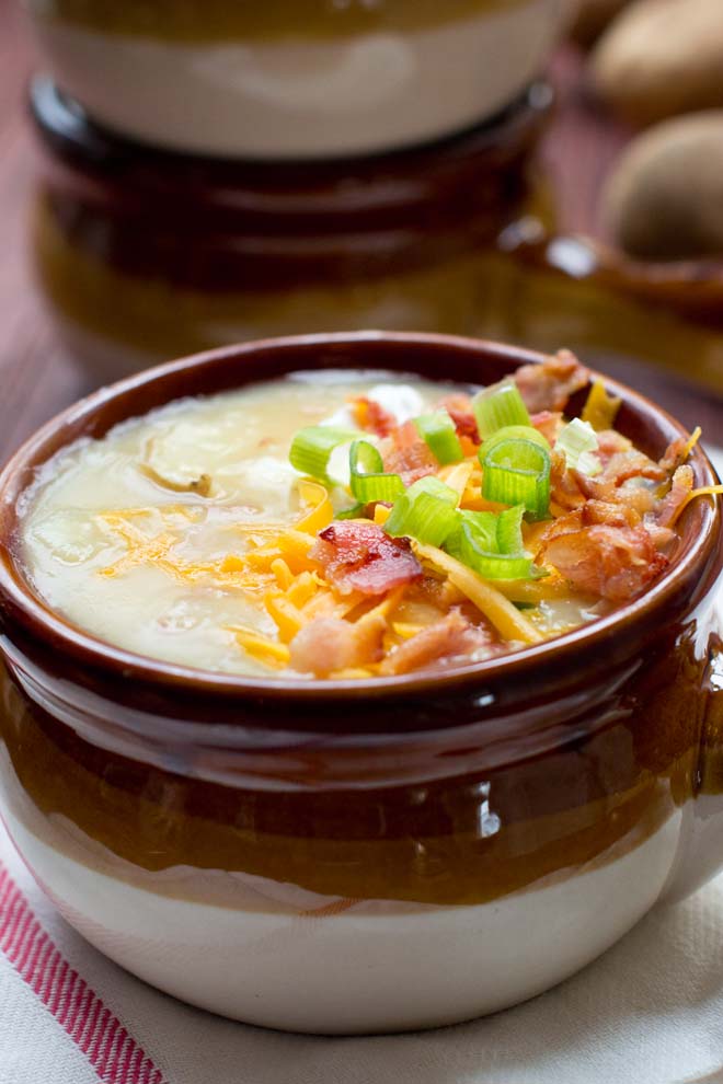 Fully Loaded Baked Potato Soup in a brown ceramic bowl.