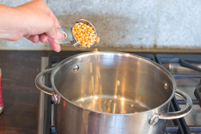 Add 1/4 cup popcorn kernels to the pot.