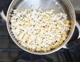 A metal pot with popcorn in it