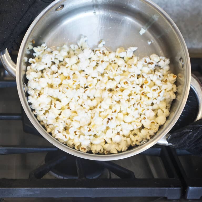 A metal pot with popcorn in it