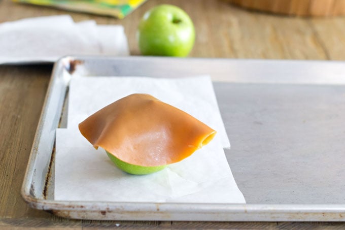 A caramel disc on an apple