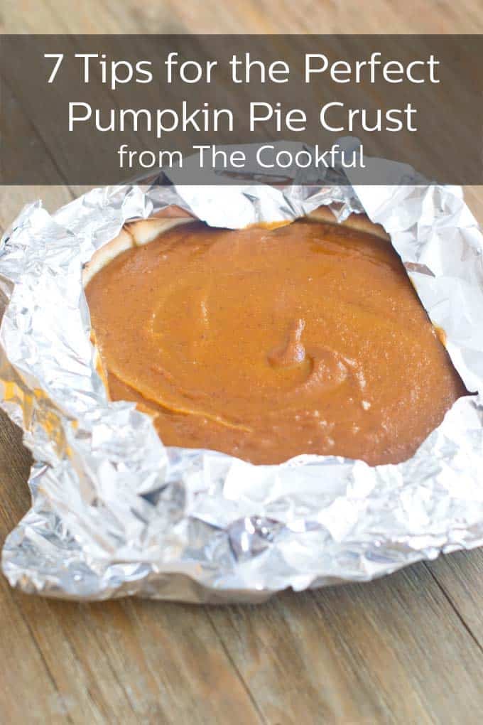 Pumpkin pie with foil around the crust, text reads 7 Tips for the Perfect Pumpkin Pie Crust from The Cookful.