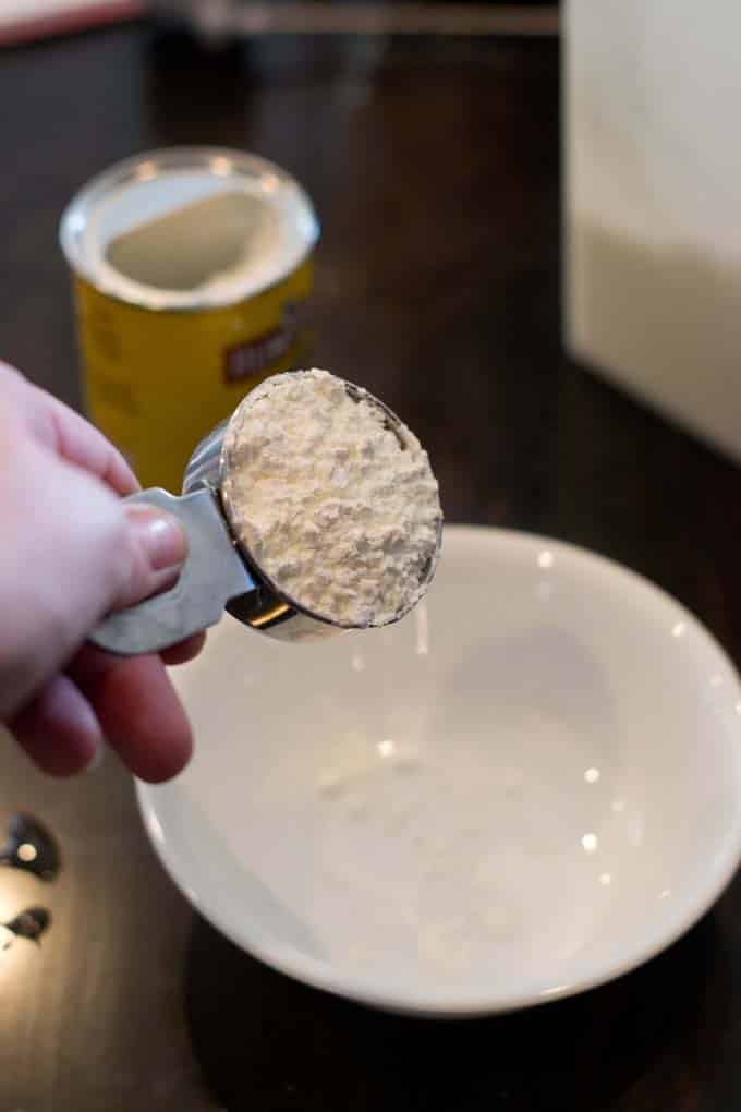 Cornstarch being poured into bowl.