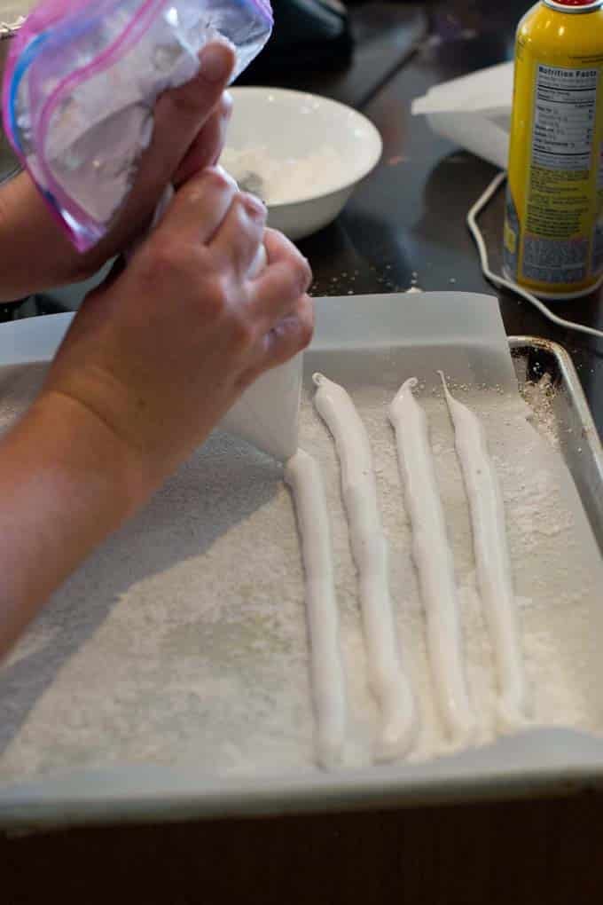 Pipe lines of marshmallow Pipe lines of marshmallow onto parchment lined sheet.
