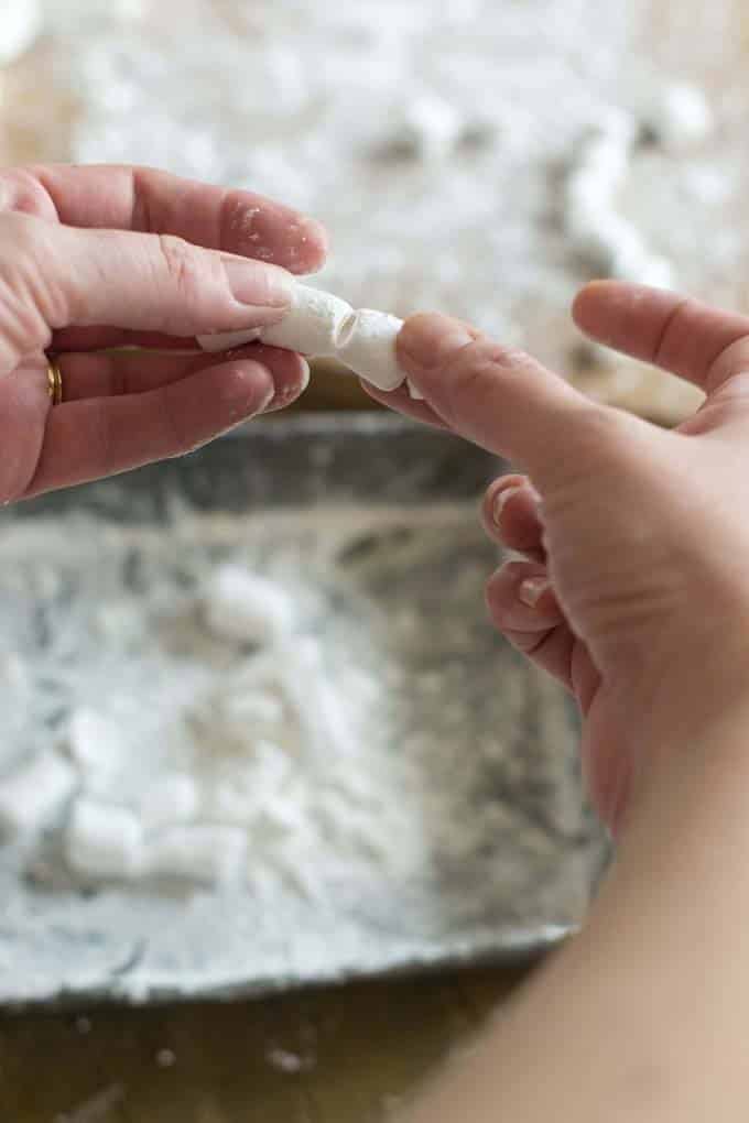 Separating mini marshmallows with fingers.