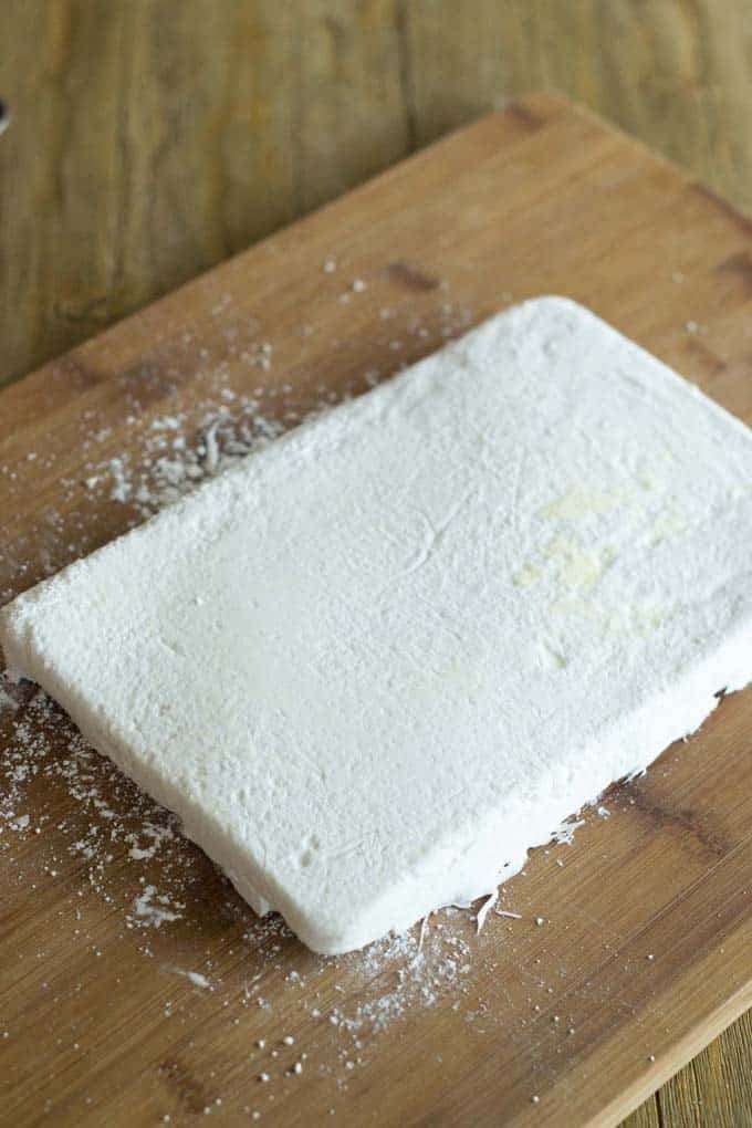 One giant mellow! One giant mallow on a cutting board.