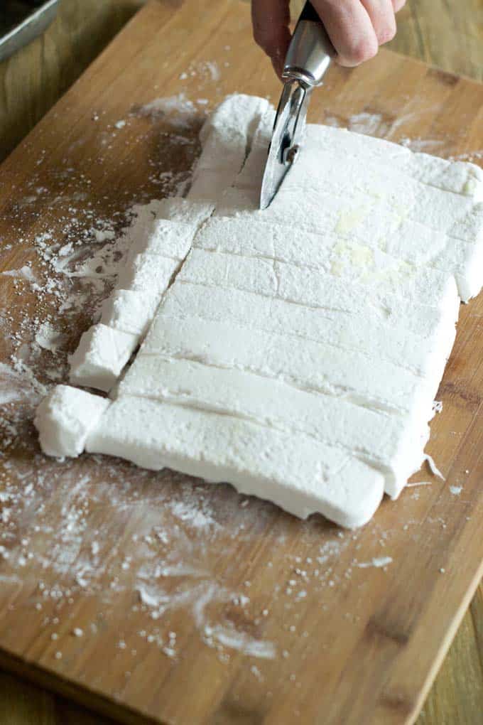 Cut strip of marshmallow into squares.