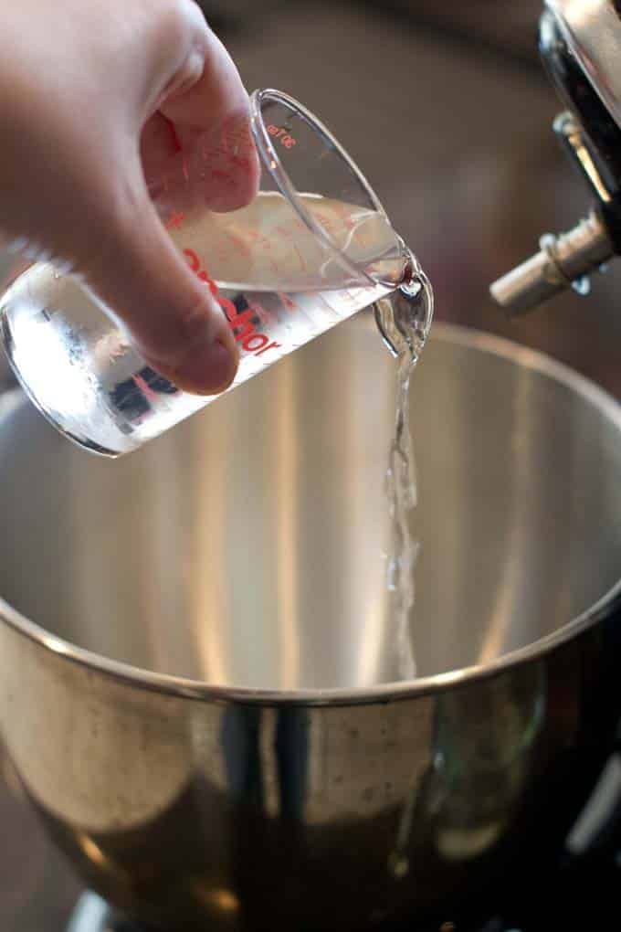 Pouring cold water into mixer.