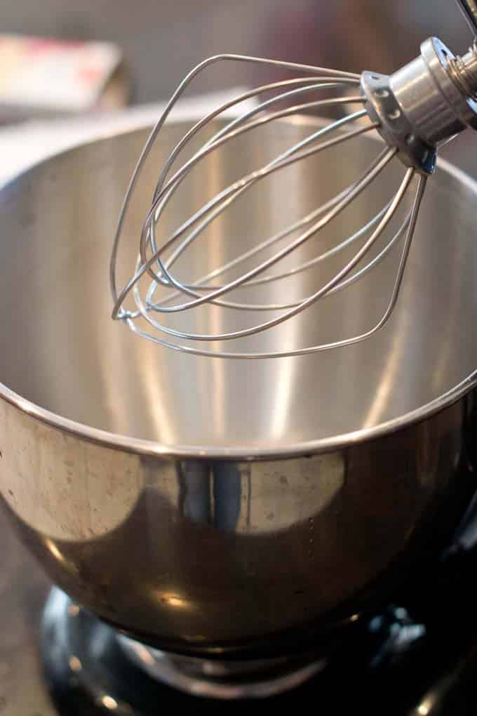 Stand mixer with whisk attachment.