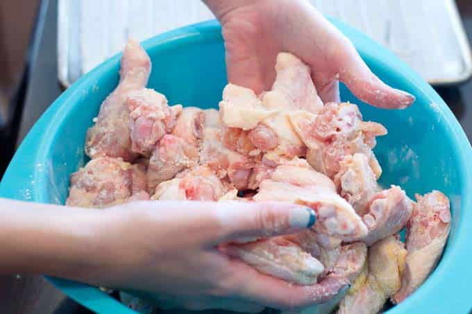Tossing the chicken with salt and baking powder