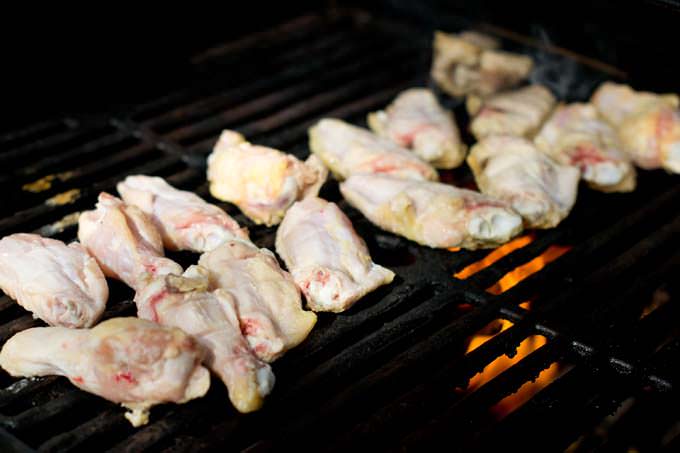 Raw chicken wings on grill