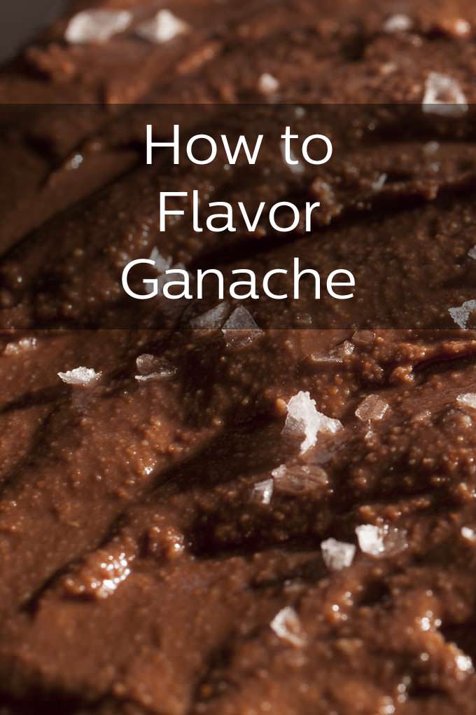 Very close up picture of chocolate ganache that has been sprinkled with flakey sea salt. The text overlay reads, "How to Flavor Ganache".