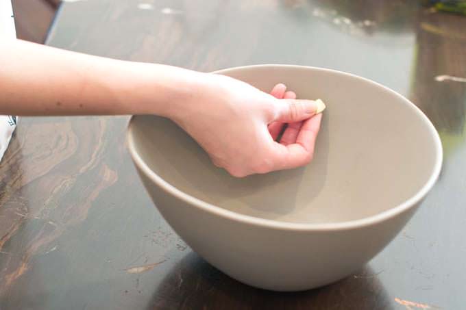 Rub garlic all around the bowl