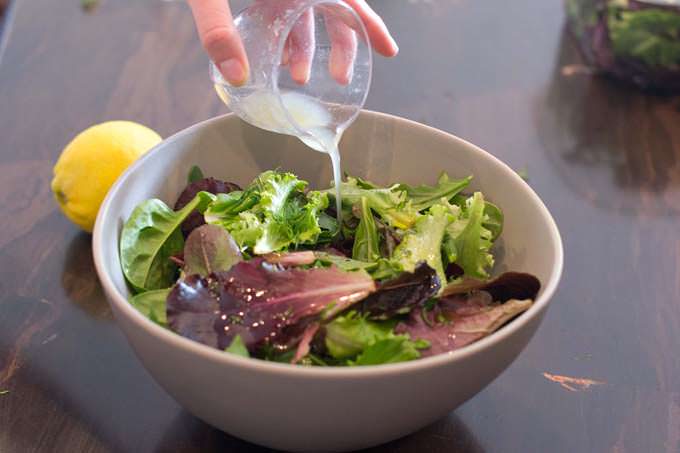 Add lemon juice to the salad greens