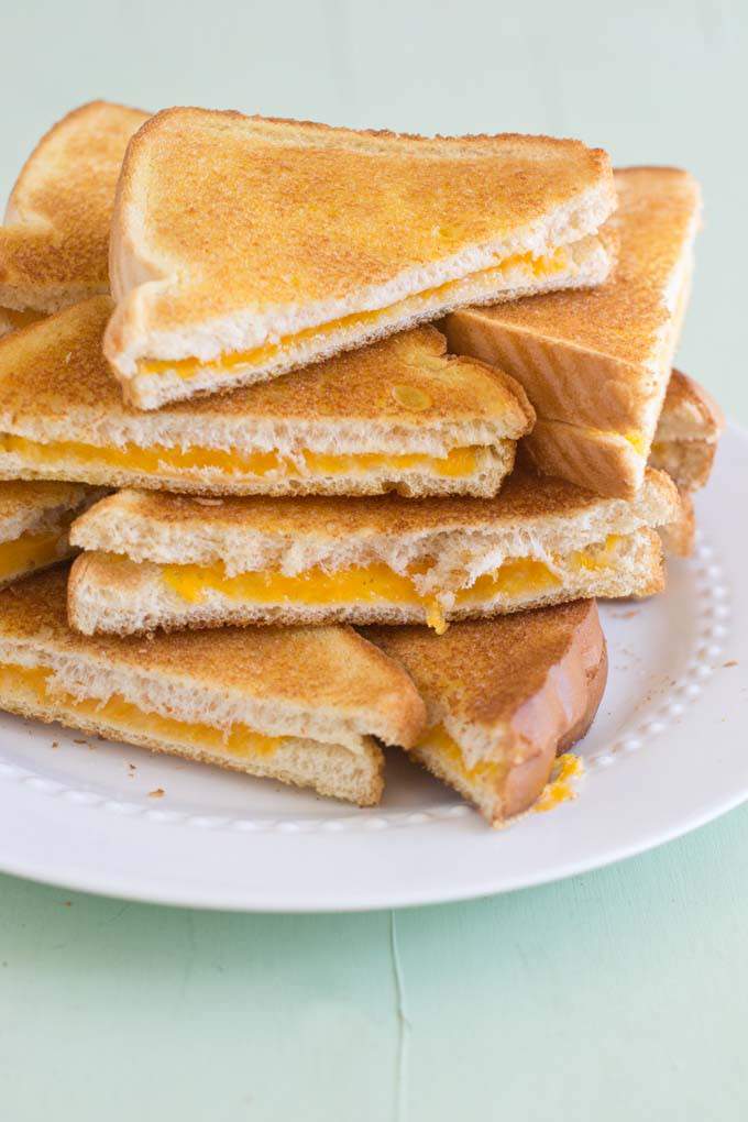 Plate with pile of grilled cheese sandwiches