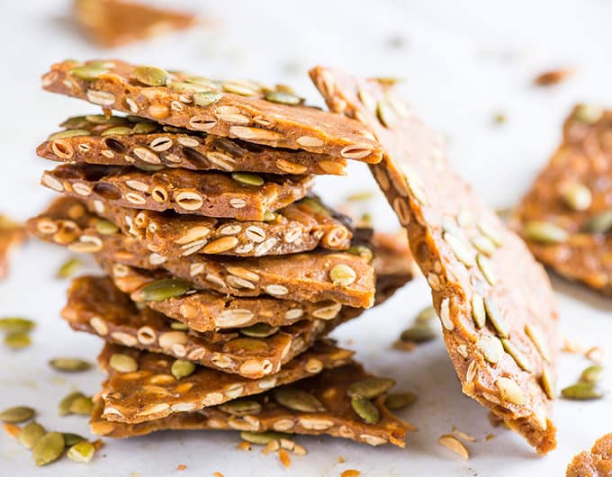 Spiced Maple Pumpkin Seed Brittle in a stack.