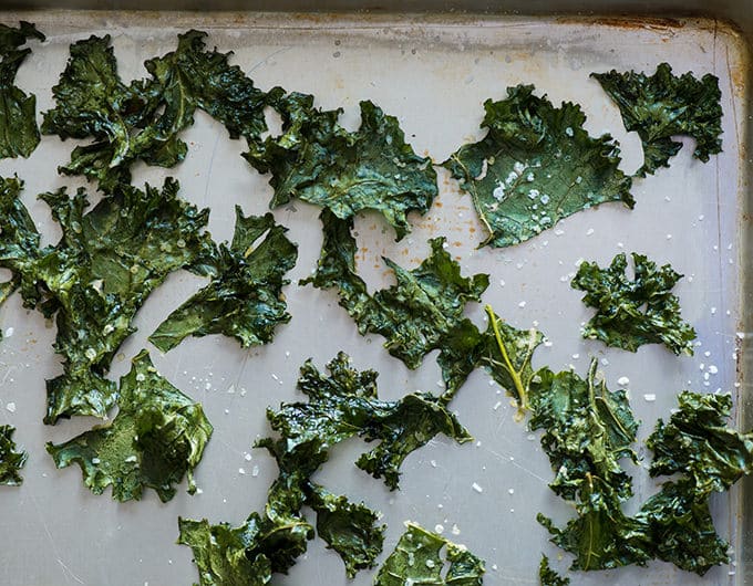 Raw kale on baking sheet to turn into kale chips
