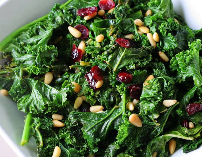 Kale can be a bit tough to eat raw in salads. But if you know how to pamper it and prepare it, it becomes the perfect salad green. Learn how here.