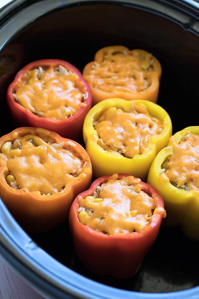 Healthy. Hearty. Easy. Pretty. DEEELicious! Chicken Stuffed Peppers in the slow cooker have it all.