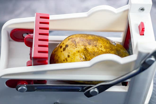 Potato in fry cutter.