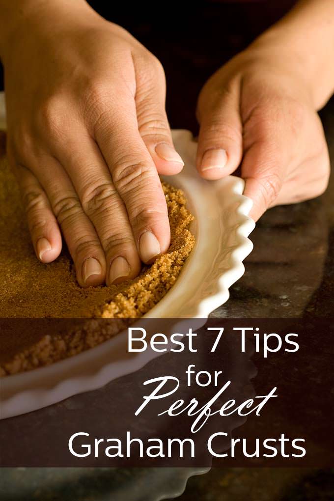 Picture of a white ceramic scalloped edge pie dish being held by one hand while the other presses the brown crumbs of graham crackers down to form a crust for cheese cake. Across the bottom of the picture is the words, "Best 7 Tips for Perfect Graham Crusts"