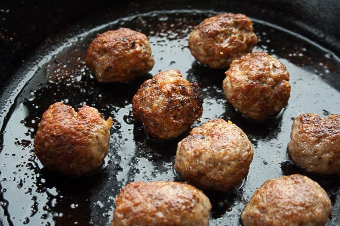 Meatballs being pan fried.