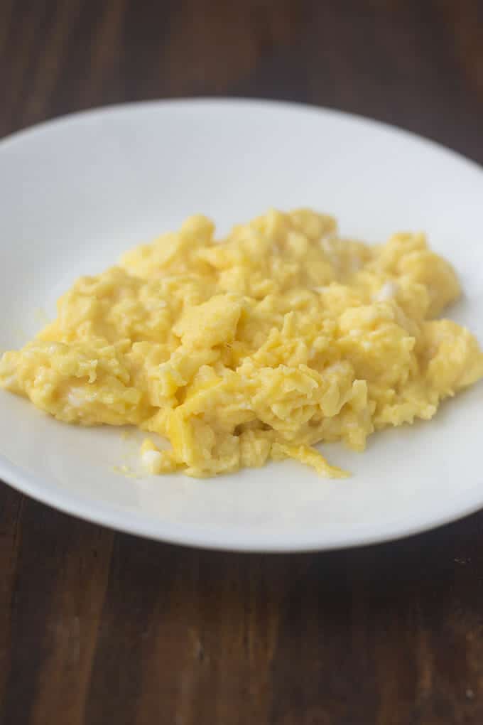 French-style scrambled eggs on a white dinner plate.