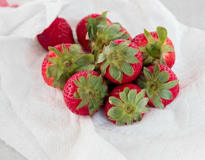 Fresh strawberries drying in a paper towel.