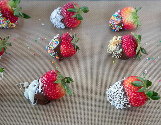 Chocolate covered strawberries on a silicon mat.