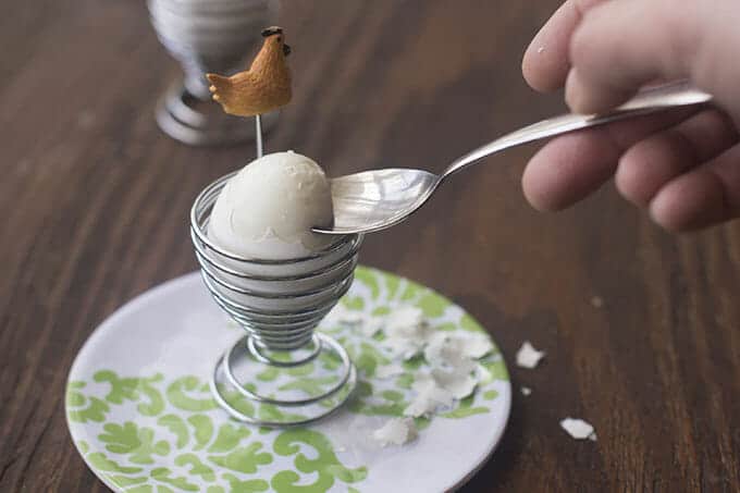 Spoon cutting into the cooked egg white of a soft boiled egg.