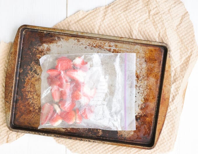 Frozen strawberries in a zip-top freezer bag.
