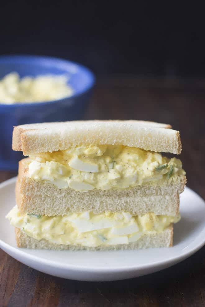 Egg salad sandwich on white plate
