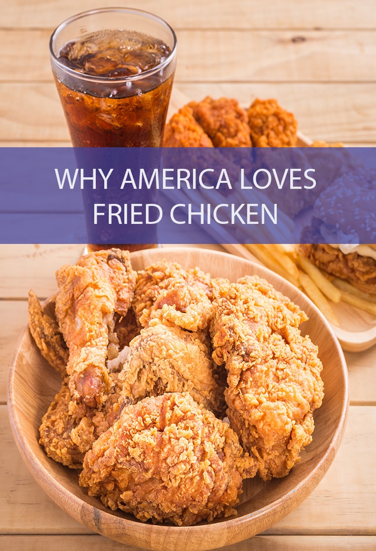 Pieces of fried chicken in a wood bowl on a wood table in front of a tall glass of iced tea. Next to the bowl is a rectangular plate with a fried chicken sandwich, french fries and some fried chicken pieces on it. Over the picture is a banner that reads, "Why America Loves Fried Chicken".
