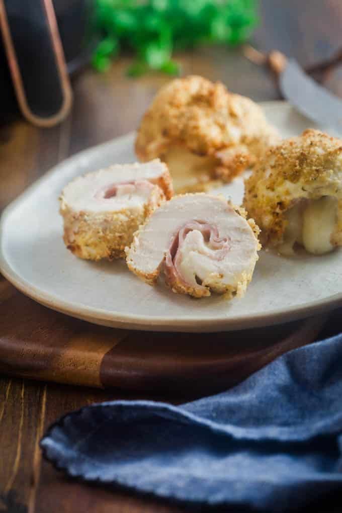 Sliced chicken cordon blue on a white plate.