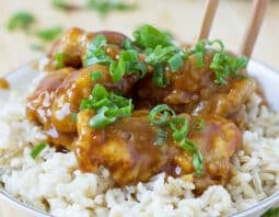 Chinese Chicken over white rice in a bowl.