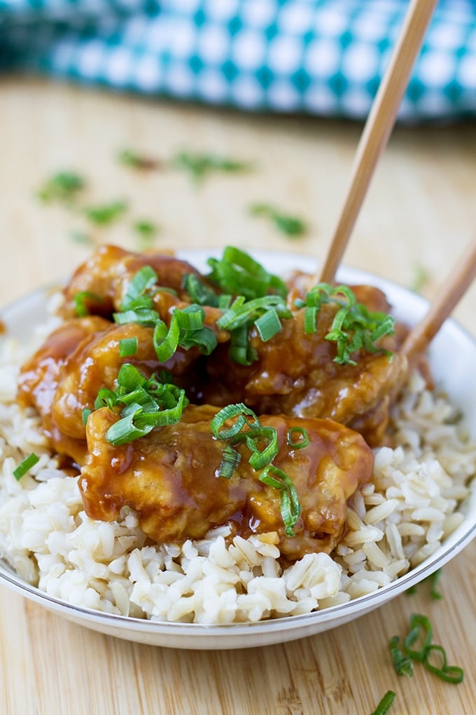 Chinese Chicken over white rice in a bowl.