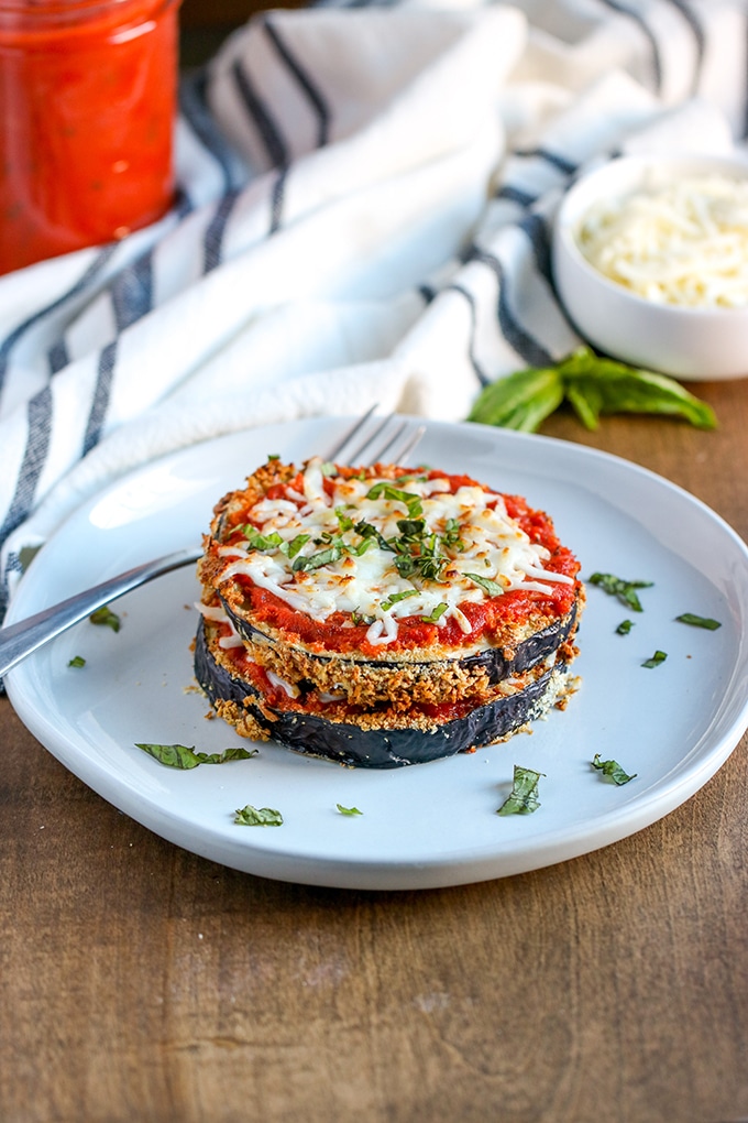 Eggplant Parmesan stack on a white plate.