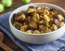 Crispy balsamic brussels sprouts in a white serving bowl.