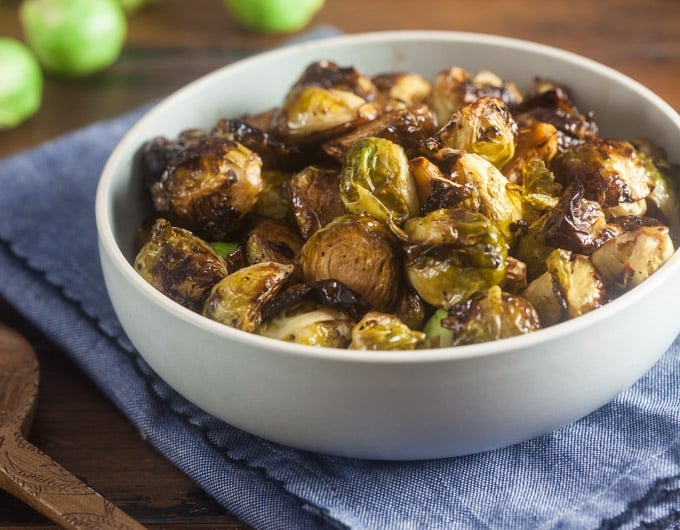 White bowl of cooked brussels sprouts.