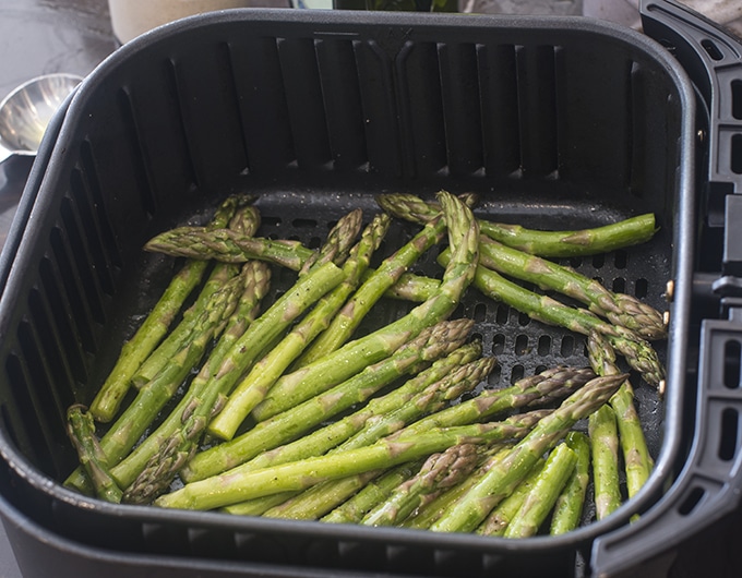 Asparagus in the basket of an air fryer