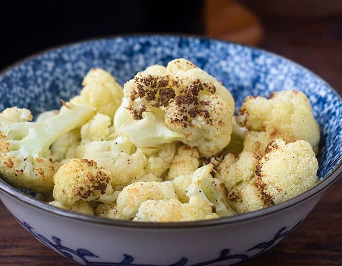 Blue and white bowl of cooked cauliflower.