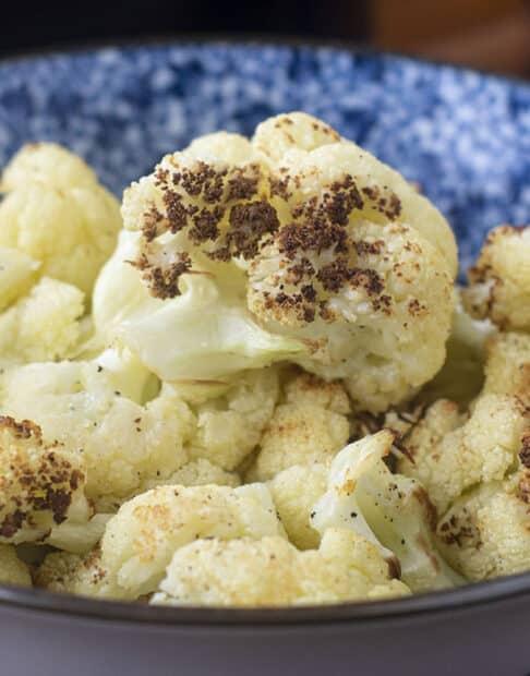 Blue and white bowl of cooked cauliflower.