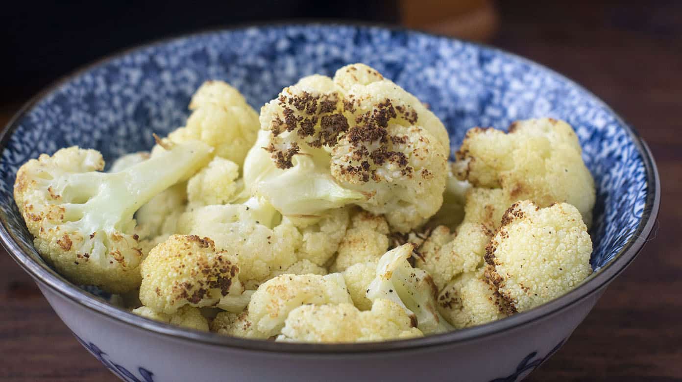 Blue and white bowl of cooked cauliflower.