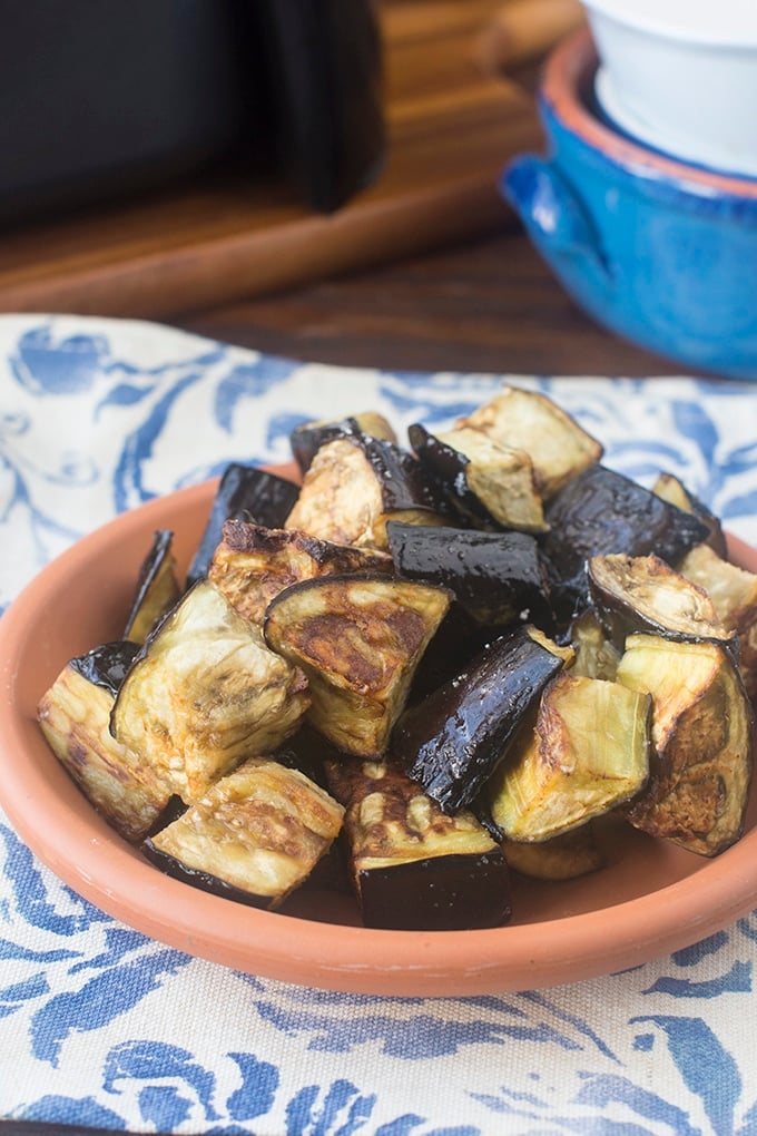 Plate of cooked eggplant pieces.