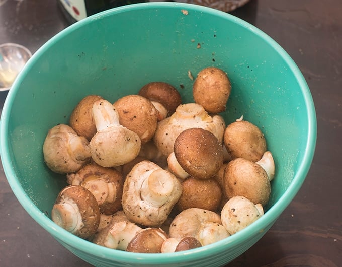 Fresh mushrooms in a light blue bowl.