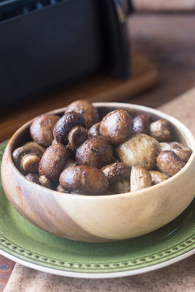 Bowl of cooked whole mushrooms.