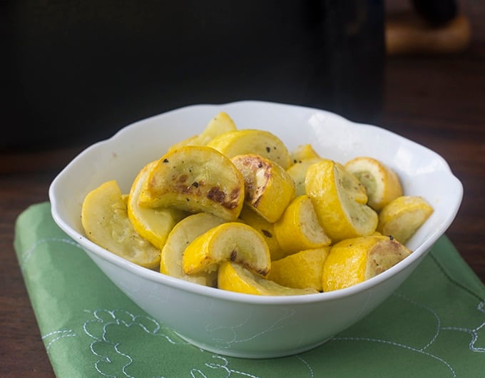 Cooked yellow squash in a white bowl