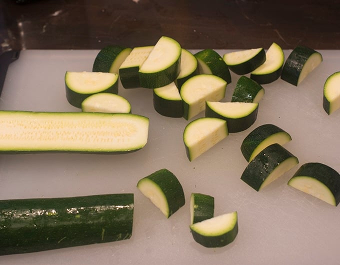 Zucchini sliced in half lengthwise, then slices.