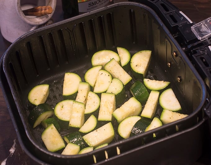 Zucchini in the air fryer basket.